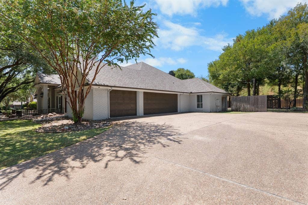 367 Elm Grove Circle, Waco, TX 76657 Stucco exterior with a shingle roof, two-car garage, and an expansive concrete driveway