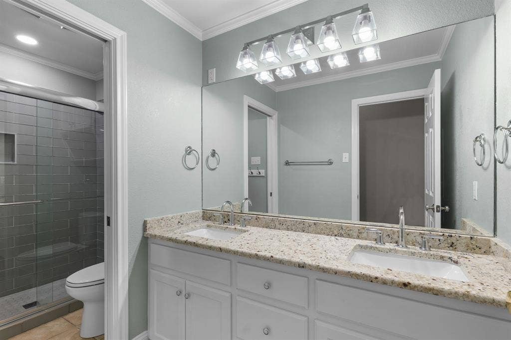 367 Elm Grove Circle, Waco, TX 76657 Dual vanity with undermount sinks, stone countertops, and chrome fixtures