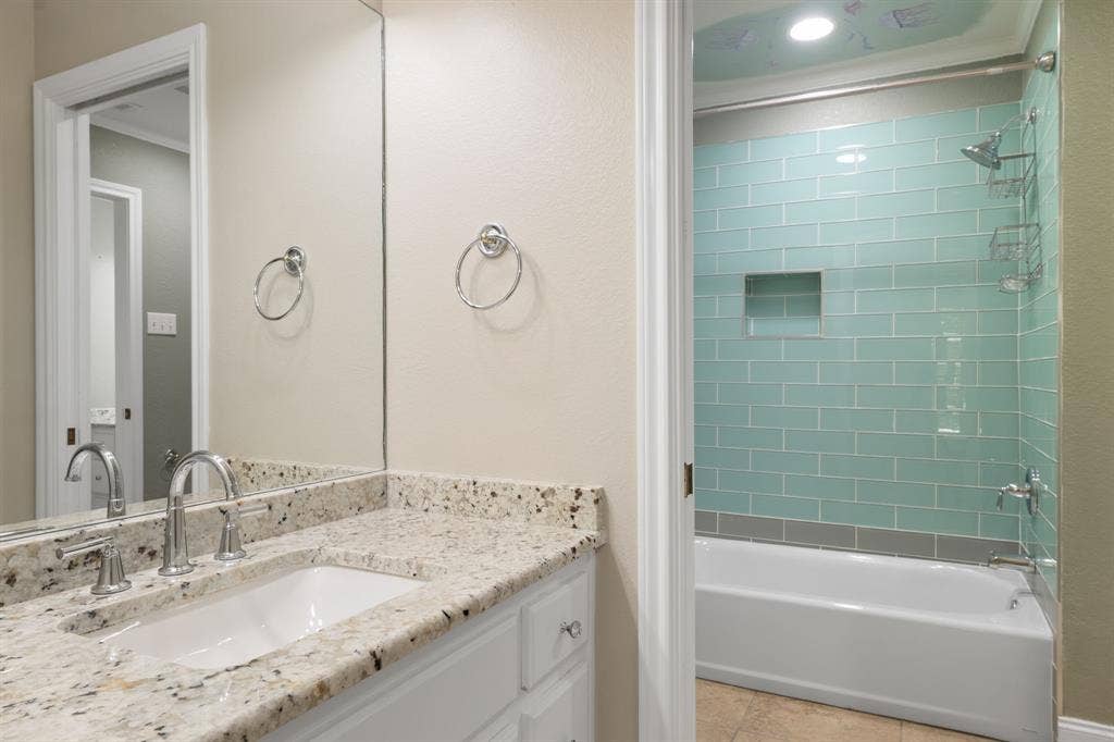 367 Elm Grove Circle, Waco, TX 76657 Granite vanity countertop with an undermount sink, chrome faucet, and full-width mirror