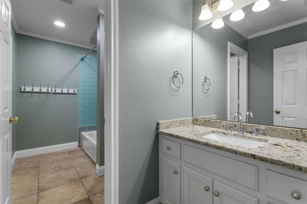 367 Elm Grove Circle, Waco, TX 76657 Bathroom featuring a vanity with a light-toned countertop, integrated sink, and white cabinetry