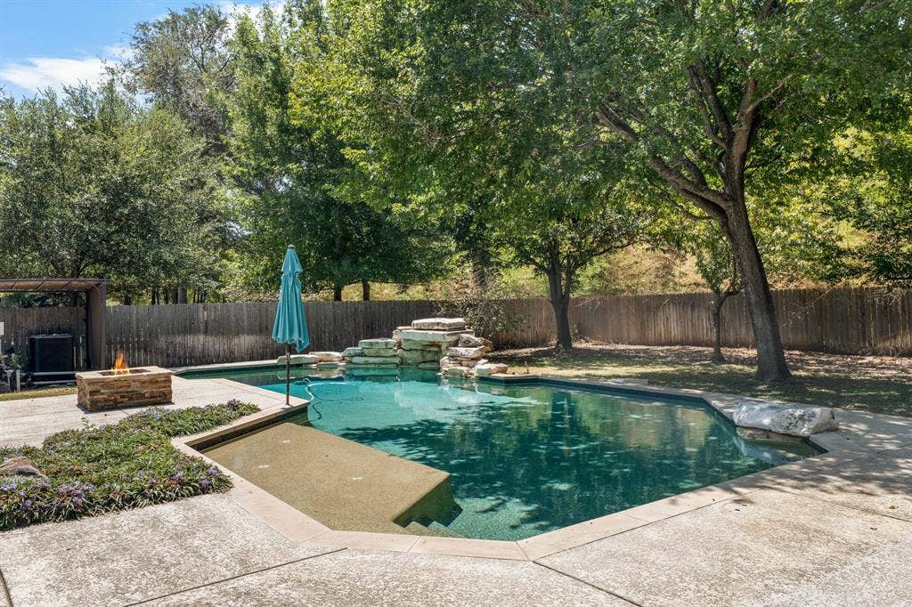 367 Elm Grove Circle, Waco, TX 76657 In-ground swimming pool featuring a rock waterfall and sun shelf