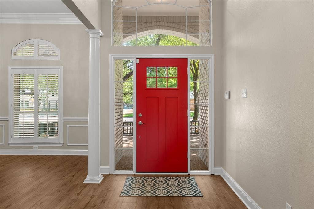 367 Elm Grove Circle, Waco, TX 76657 Red entry door with transom window and sidelights, wood-finish flooring, decorative wall paneling, and architectural column