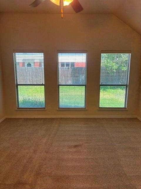 1111 Whitaker Way, Glenn Heights, TX 75154 Vaulted ceiling with a ceiling fan, three horizontal windows with blinds, and neutral-toned carpeting
