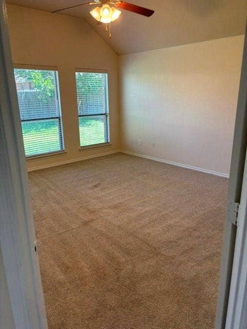 1111 Whitaker Way, Glenn Heights, TX 75154 Vaulted ceiling with a ceiling fan, two windows with horizontal blinds, and carpeting