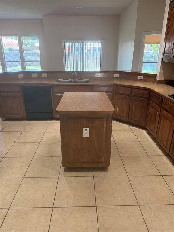 1111 Whitaker Way, Glenn Heights, TX 75154 Kitchen featuring a central island, tile flooring, wood-finish cabinetry, a double basin sink, and a built-in dishwasher