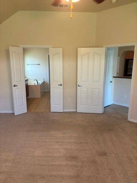 1111 Whitaker Way, Glenn Heights, TX 75154 Vaulted ceiling with a ceiling fan, carpet flooring, and paneled doors