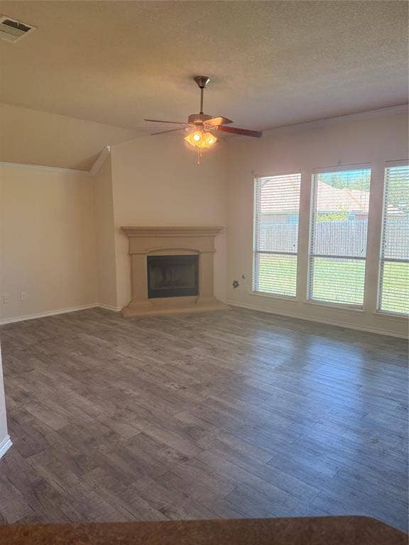 1111 Whitaker Way, Glenn Heights, TX 75154 Spacious room featuring wood-finish flooring, a ceiling fan, and multiple windows with blinds