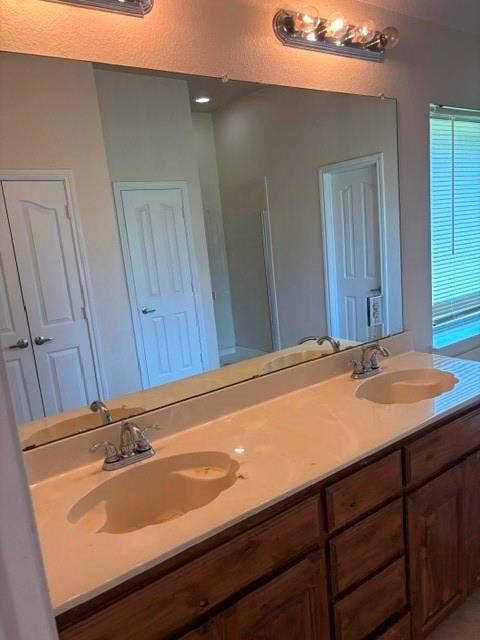 1111 Whitaker Way, Glenn Heights, TX 75154 Double vanity with integrated sinks, chrome faucets, and a light-colored countertop