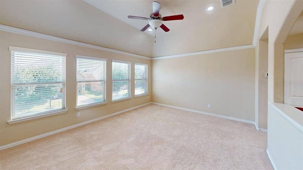Vaulted ceiling with a ceiling fan, recessed lighting, carpet flooring, and multiple windows with blinds