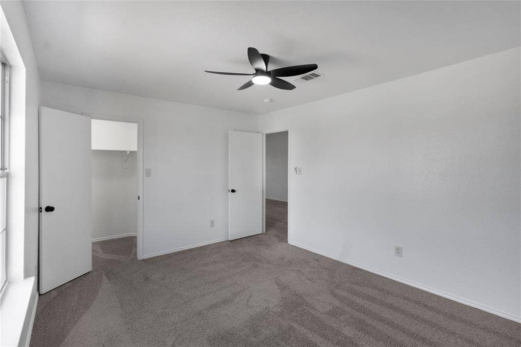 408 Centennial Place, Crowley, TX 76036 Neutral toned carpeting, white walls, black ceiling fan, white trim, and white doors