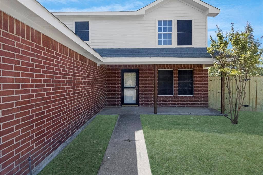 408 Centennial Place, Crowley, TX 76036 Brick and siding exterior with a covered porch, concrete walkway, and a wooden privacy fence