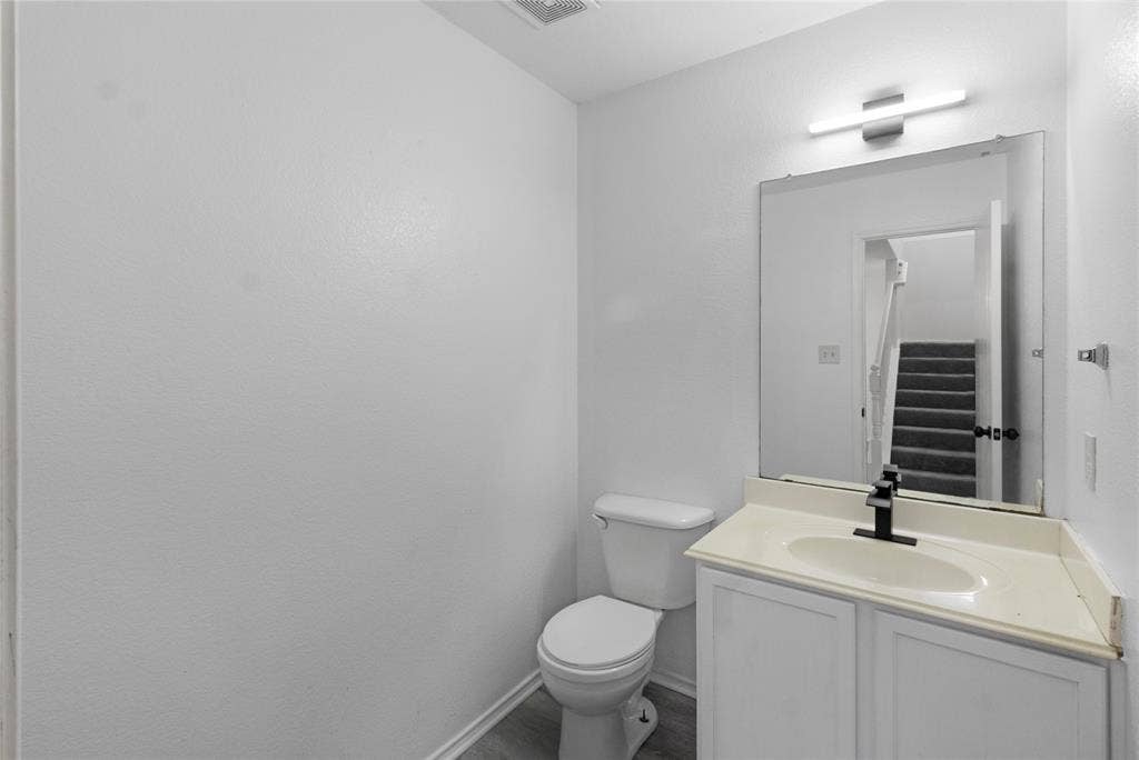 408 Centennial Place, Crowley, TX 76036 White vanity with white cabinets, light-toned countertop, and a rectangular undermount sink