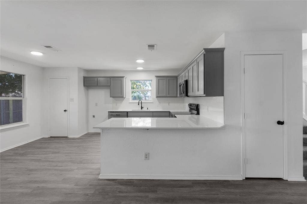 408 Centennial Place, Crowley, TX 76036 Kitchen featuring white countertops, gray cabinetry, a white subway tile backsplash, and black appliances