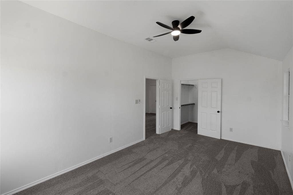 408 Centennial Place, Crowley, TX 76036 Vaulted ceiling with a ceiling fan, plush carpet flooring, and a walk-in closet with shelving