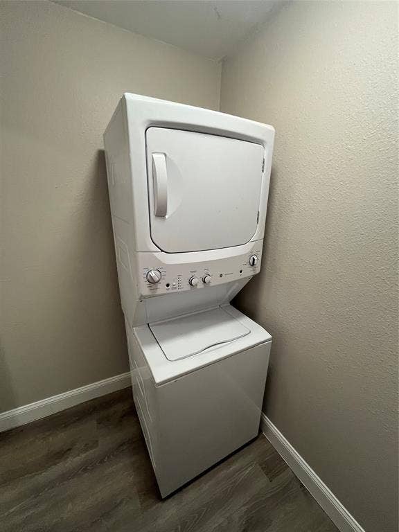 820 E Edith Street, Irving, TX 75061 White stacked washer and dryer unit, neutral wall color, and wood-finish flooring