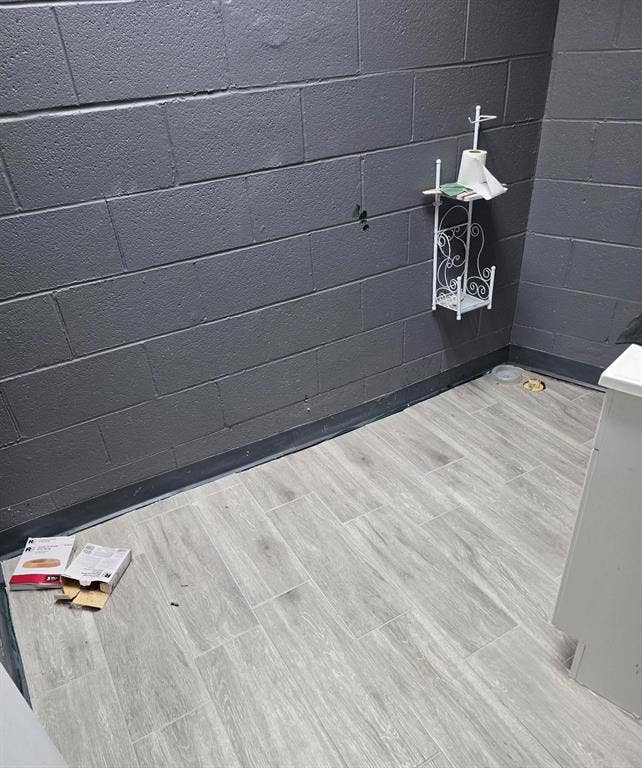 4309 Action Street, Garland, TX 75042 Gray wood-look plank flooring complements the dark gray block wall construction
