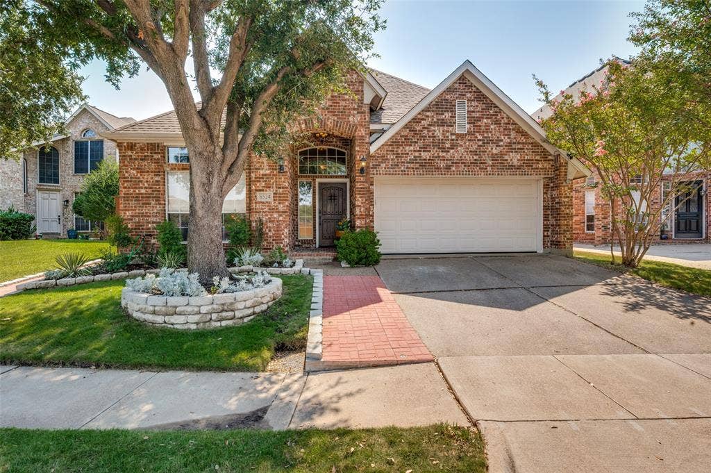 8524 Wellington Point Drive, Irving, TX 75063 Brick exterior with stone accents and an arched entryway