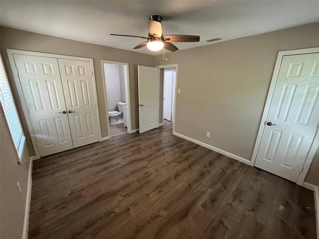 1843 Greendale Drive, Dallas, TX 75217 Wood-finish flooring, ceiling fan with integrated lighting, paneled doors, and neutral wall tones