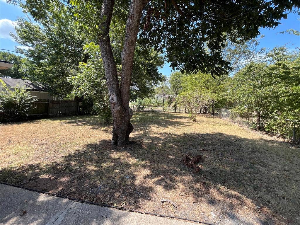 1843 Greendale Drive, Dallas, TX 75217 Spacious lot featuring mature trees and established perimeter fencing