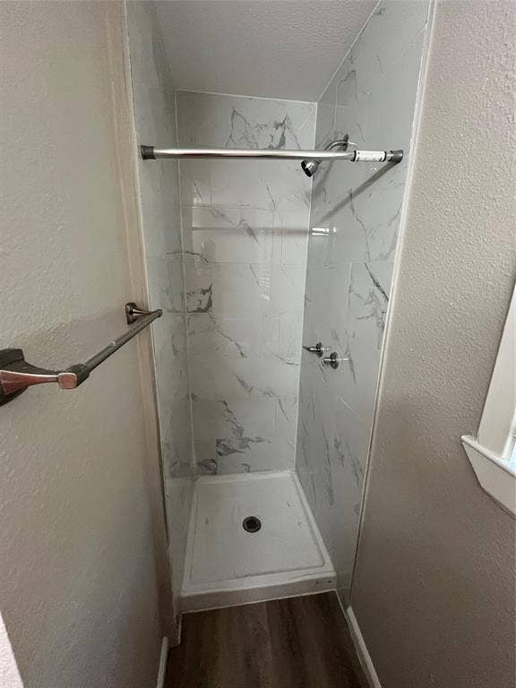 1843 Greendale Drive, Dallas, TX 75217 Walk-in shower with white-patterned wall panels, a white shower pan, and chrome fixtures