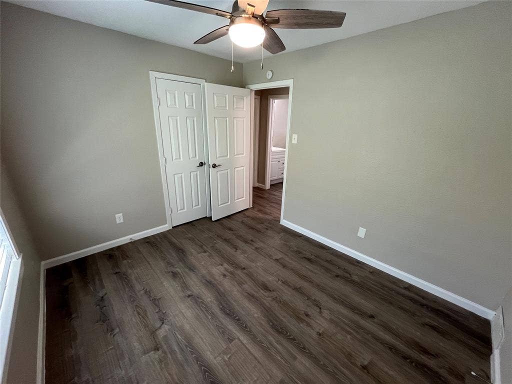 1843 Greendale Drive, Dallas, TX 75217 Wood-finish flooring, neutral wall paint, ceiling fan with integrated lighting, and white trim
