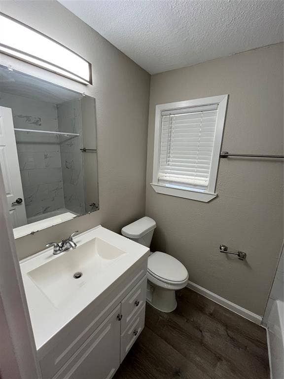 1843 Greendale Drive, Dallas, TX 75217 White vanity with integrated sink, chrome faucet, wood-finish flooring, and window with blinds