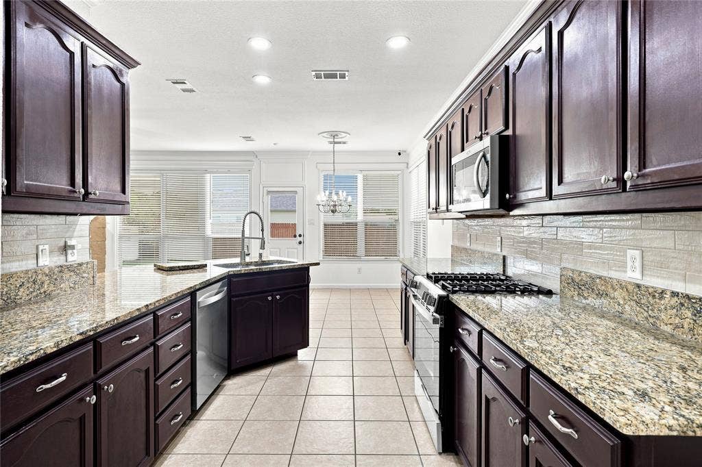 6427 Miranda Drive, Fort Worth, TX 76131 Granite counters in this galley style kitchen.