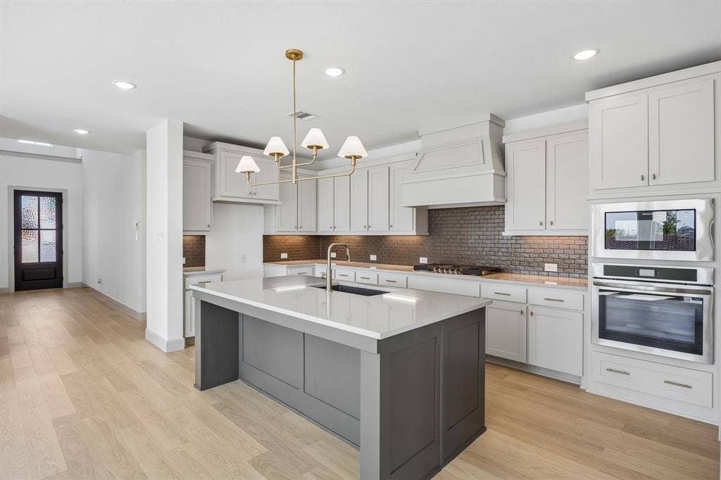 2312 Wispy Lane, Celina, TX 75009 This brand new dream kitchen features gorgeous cabinetry, contemporary countertops, and stainless appliances.