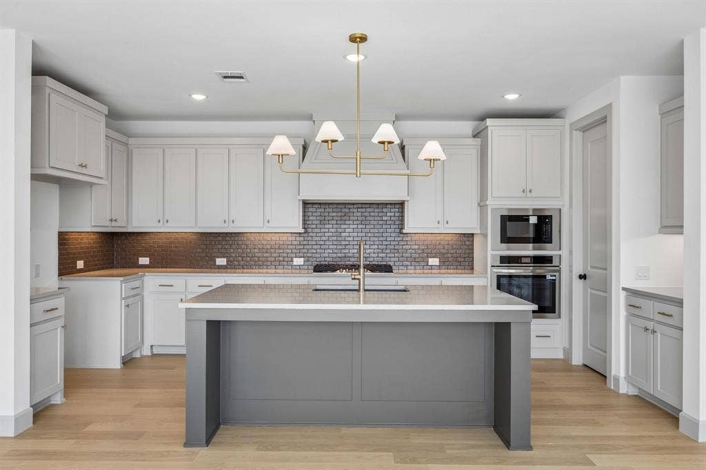 2312 Wispy Lane, Celina, TX 75009 The spacious kitchen island offers the perfect place for friends and family to gather round!