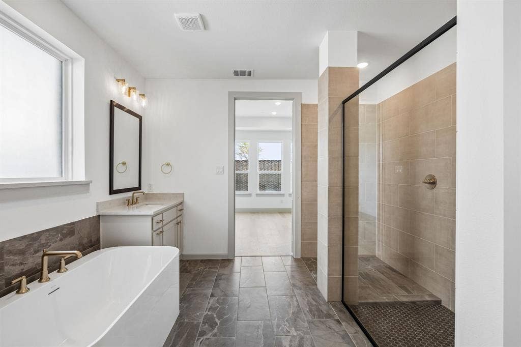 2312 Wispy Lane, Celina, TX 75009 This dream owner's bath offers ample room for two with dual vanities and a luxurious free standing tub!