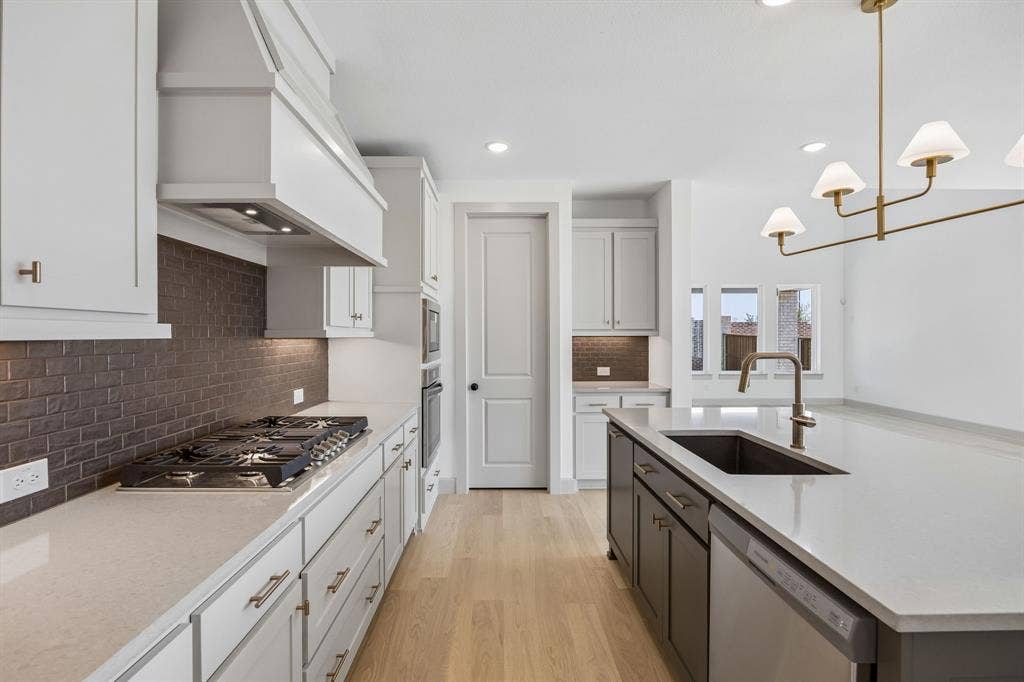 2312 Wispy Lane, Celina, TX 75009 You'll find thoughtful design elements like pull out trash, pot & pan drawers and walk in pantry throughout this chef's dream kitchen!