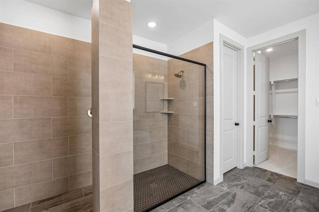 2312 Wispy Lane, Celina, TX 75009 Featuring a spacious walk in shower with drying area and outstanding owner's closet, this dream bath is waiting for you to call it your own!