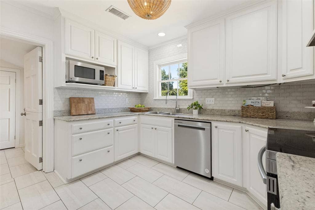 Stainless appliances and a kitchen faucet are recent additions to this well-appointed kitchen with ample storage.
