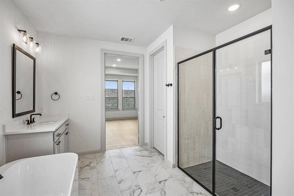 2308 Wispy Lane, Celina, TX 75009 Whether it's soaking you cares away in the beautiful tub or indulging in a long luxurious shower...this owner's bath is a dream come true!