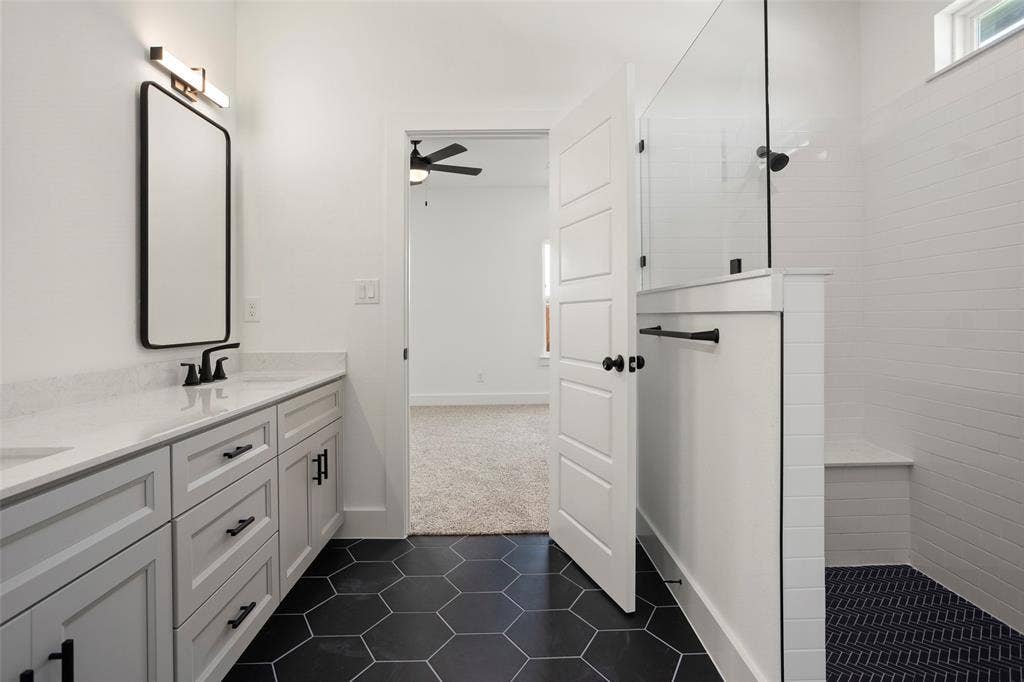 200 Cliff Court, Godley, TX 76044 Bathroom featuring a tile shower, tile patterned floors, double sink vanity, and ceiling fan