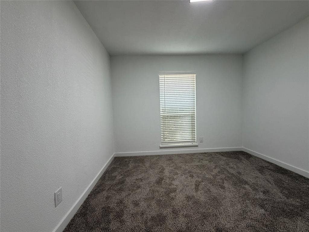 Window with horizontal blinds, textured walls, wall-to-wall carpeting, and recessed ceiling lighting