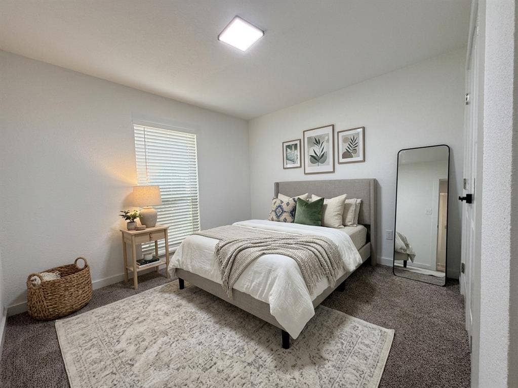 Staged- Carpeted flooring, window with blinds, recessed lighting, and a neutral color palette