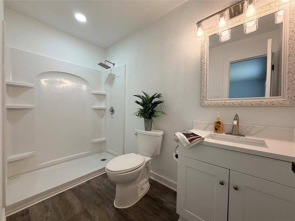 Modern bathroom with a white vanity featuring a quartz-finish countertop and undermount sink