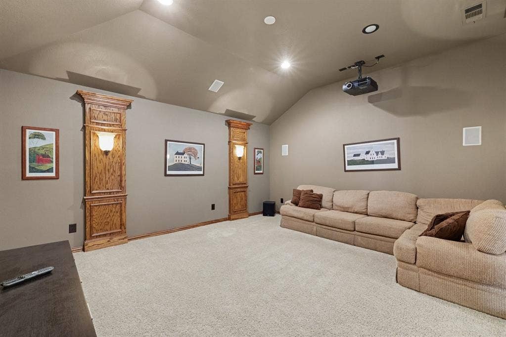 408 Blue Ridge Court, Allen, TX 75013 Vaulted ceiling, recessed lighting, built-in wall sconces with wood-finish trim, wall-mounted speakers, and ceiling-mounted projector