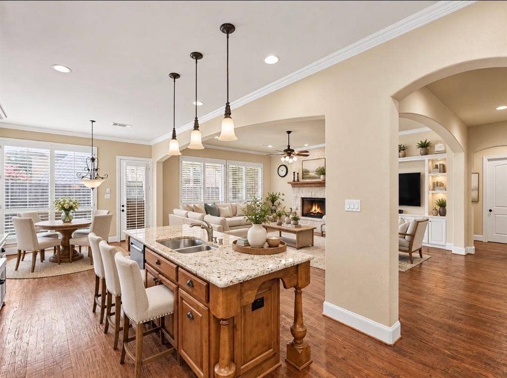 408 Blue Ridge Court, Allen, TX 75013 Kitchen island with granite countertop, double basin sink, and pendant lighting