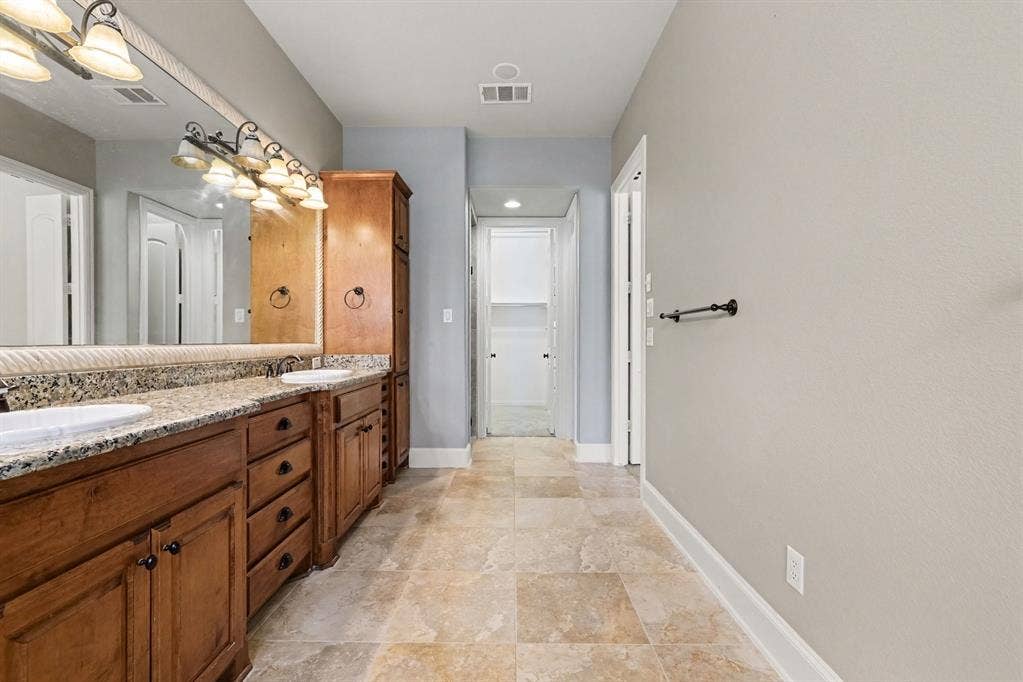 408 Blue Ridge Court, Allen, TX 75013 Dual vanity with wood cabinetry, granite-finish countertop, and integrated sinks