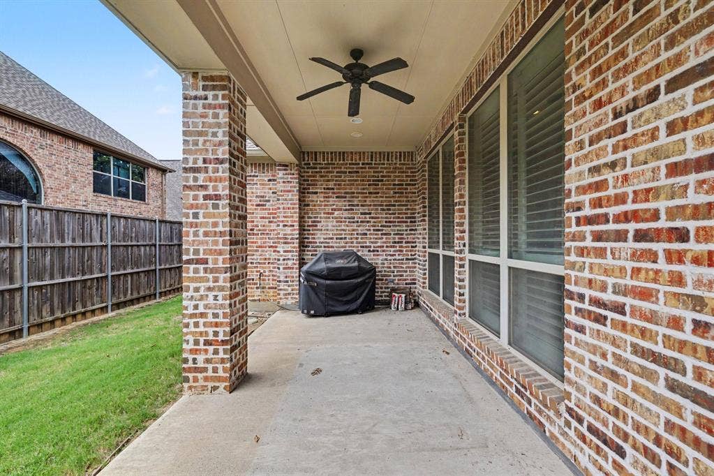 408 Blue Ridge Court, Allen, TX 75013 Covered patio with a ceiling fan, brick exterior, and a privacy fence