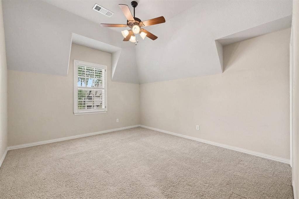 408 Blue Ridge Court, Allen, TX 75013 Vaulted ceiling with a ceiling fan, plush carpet flooring, window with shutters, and architectural dormer details