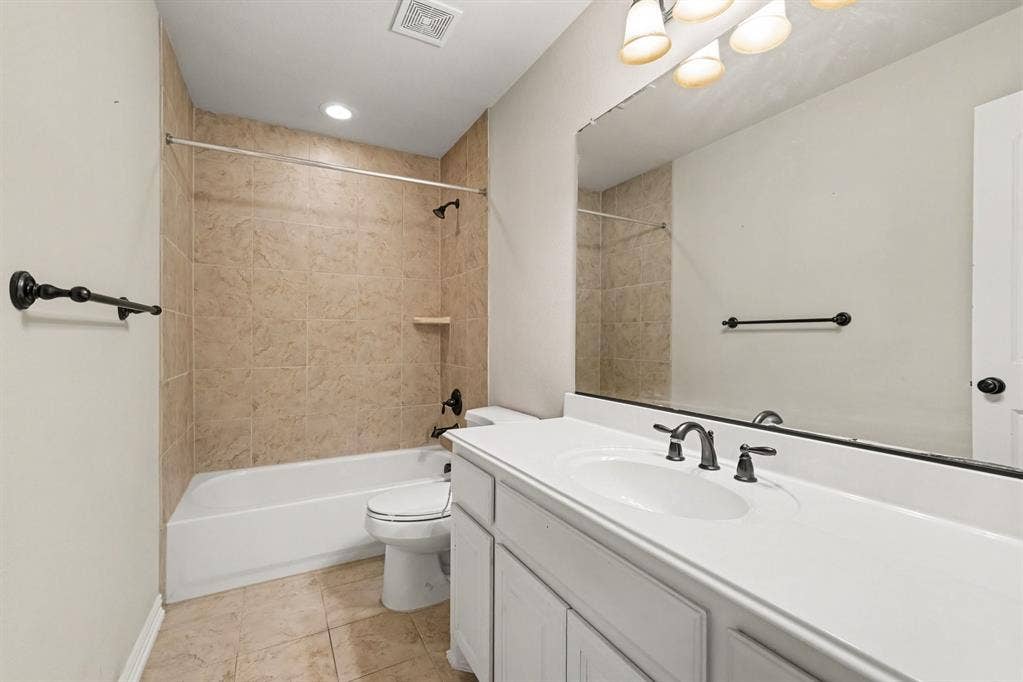 408 Blue Ridge Court, Allen, TX 75013 Bathroom featuring a single vanity with a white countertop, under-mount sink, and dark-toned fixtures. Located in secondary masterbdrm