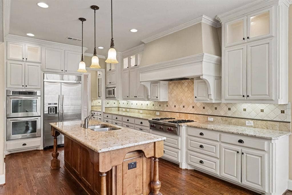 408 Blue Ridge Court, Allen, TX 75013 White cabinetry with dark hardware, recessed lighting, wood-finish flooring, and custom refrigerator
