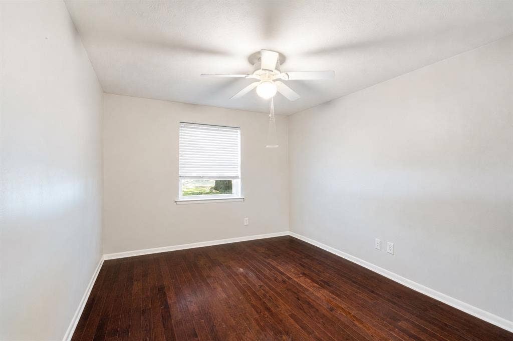 2711 Alco Avenue, Dallas, TX 75211 Wood-finish flooring, white walls, and a ceiling fan with integrated lighting
