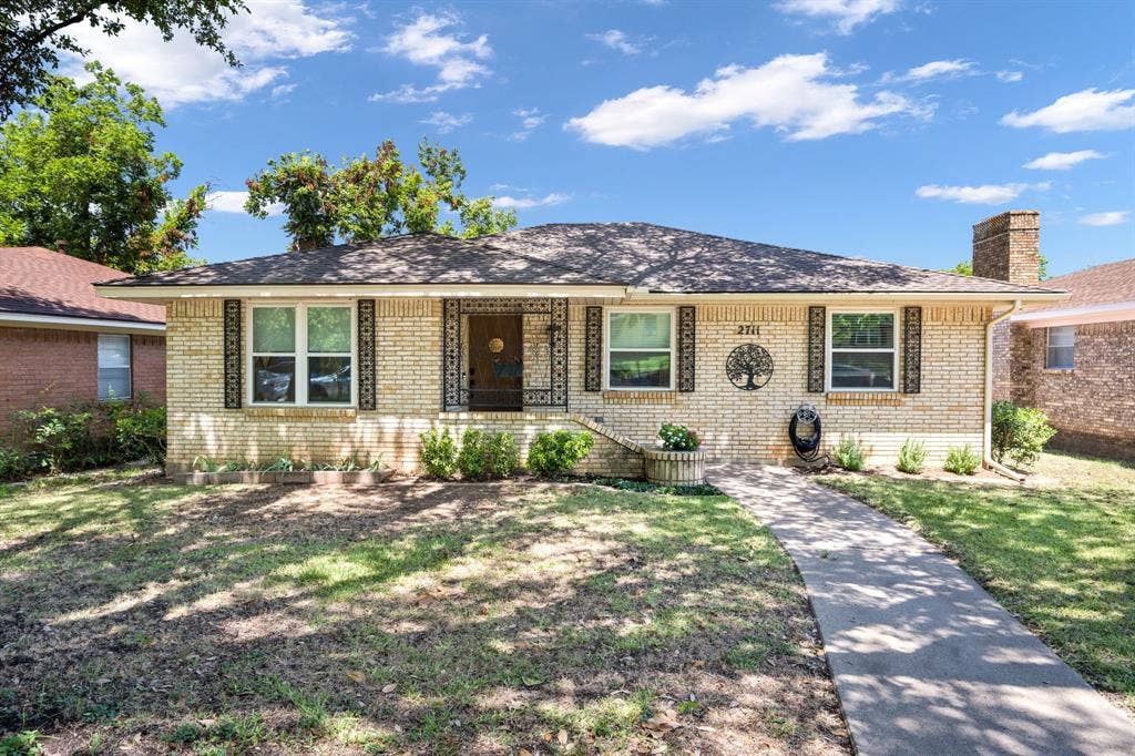 2711 Alco Avenue, Dallas, TX 75211 Brick exterior with a gabled roof and a prominent brick chimney