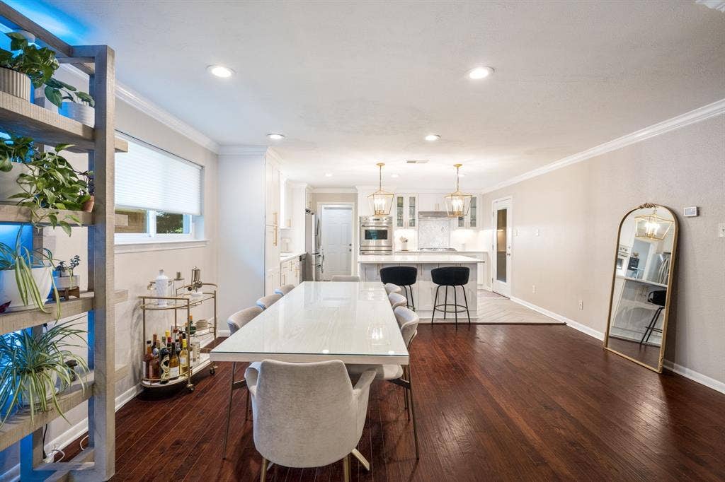 2711 Alco Avenue, Dallas, TX 75211 Open-concept living area with dark wood-finish flooring, recessed lighting, and crown molding