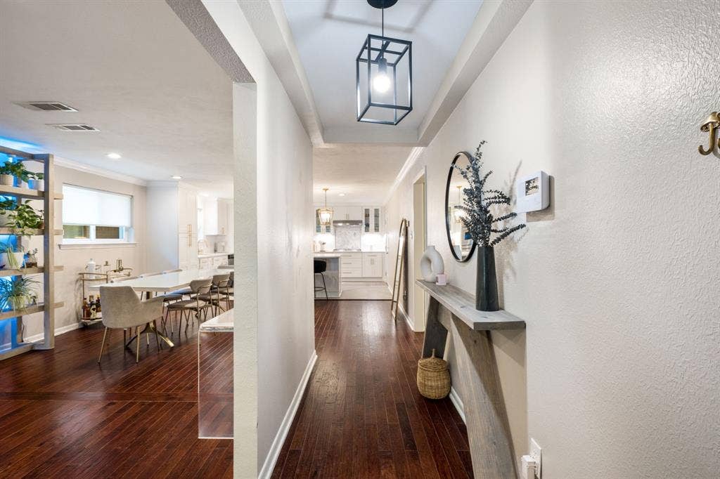 2711 Alco Avenue, Dallas, TX 75211 Wood-finish flooring throughout, tray ceiling with a black lantern-style pendant light, and recessed lighting