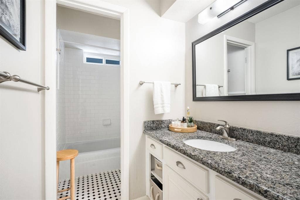 2711 Alco Avenue, Dallas, TX 75211 Vanity with a granite countertop, undermount sink, and brushed nickel faucet